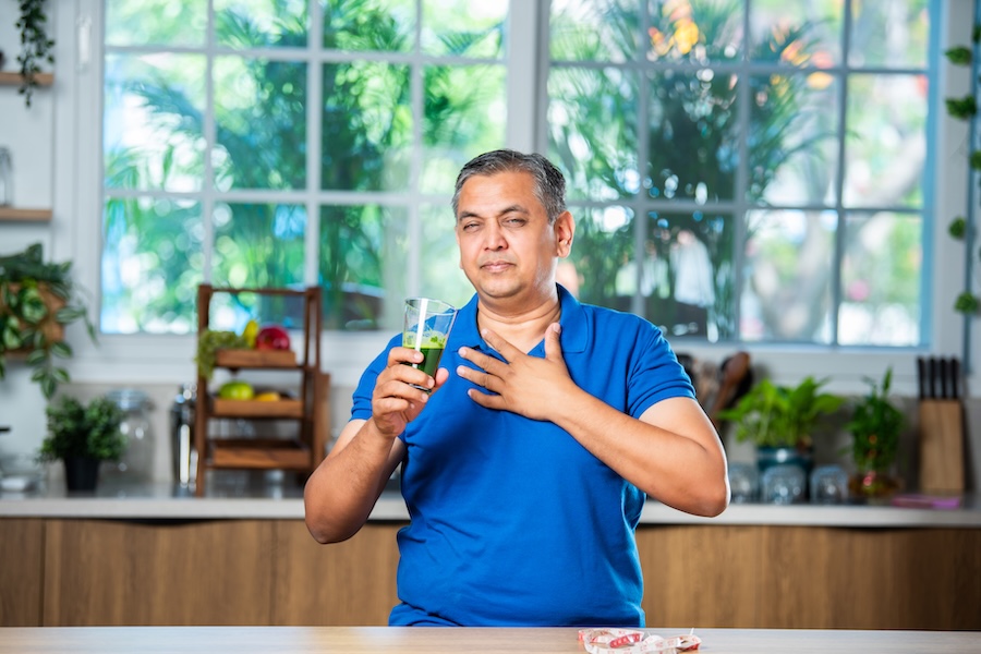 asian indian man in 40s having fresh freen juice i 2025 01 16 12 58 02 utc